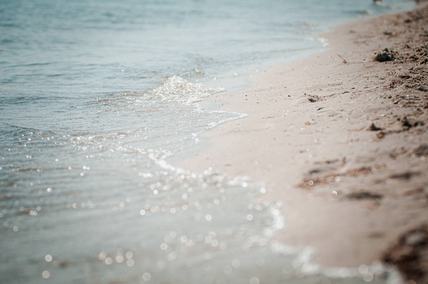 tengeri hullám mossa a homokos parton - Fotó, kép
