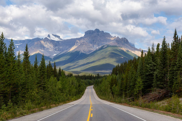 Scenic Empty road in the Canadian Rockies during a vibrant sunny and cloudy summer morning. Taken in Icefields Parkway, Banff National Park, Alberta, Canada. - Photo, image