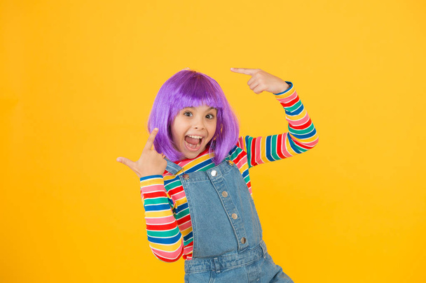 Change color. Fantasy hair trend. Kid girl with bright vibrant hairstyle. Artificial wig concept. Pigment dye hair. Growing freedom for self expression. Coloring childs hair great way upgrade costume - Foto, Imagen