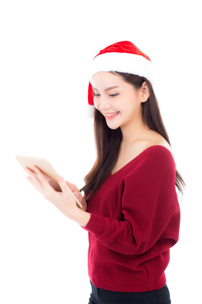 Beautiful young asian woman in red dress with christmas hat hold - Photo, Image