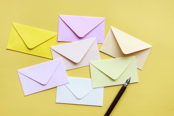 Colorful envelopes on yellow background - Zdjęcie, obraz