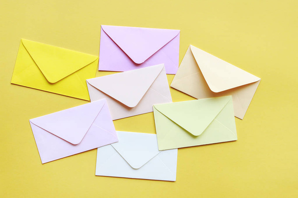 Colorful envelopes on yellow background - Φωτογραφία, εικόνα