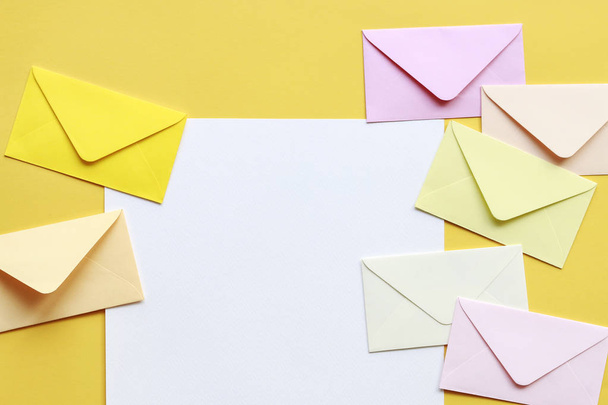 Colorful envelopes on yellow background - Foto, afbeelding