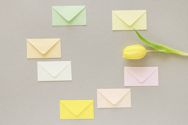 Colorful envelopes on grey paper background, copy space. - Zdjęcie, obraz