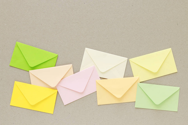 Colorful envelopes on grey paper background, copy space. - Foto, Bild