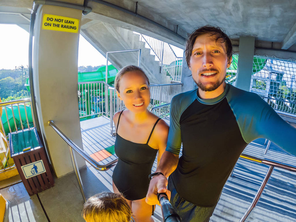 Family - mom, dad and son are standing in line at the water park - Photo, Image