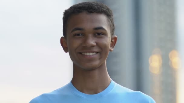 Glad afro-american male teen smiling on camera, volunteer project, motivation - Filmagem, Vídeo