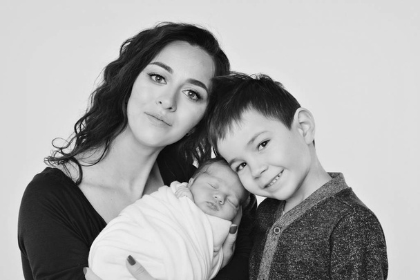 family photo on a white background: woman and boy spend time with children. hug the baby. the concept of childhood, fatherhood, motherhood, IVF - Fotoğraf, Görsel