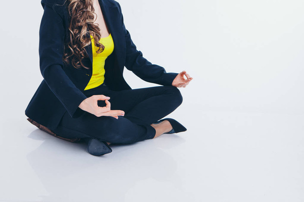 businesswoman meditating. Preparation of a potion on a white background. Singing bowl with Buddhist mantra in woman's hand in a suit - Foto, Imagen
