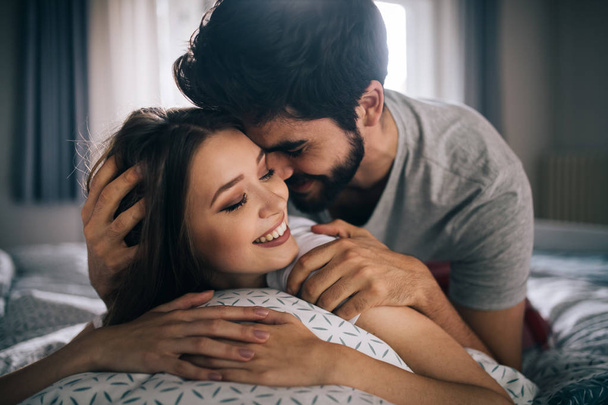 Cheerful young happy couple making massage at home - Photo, Image