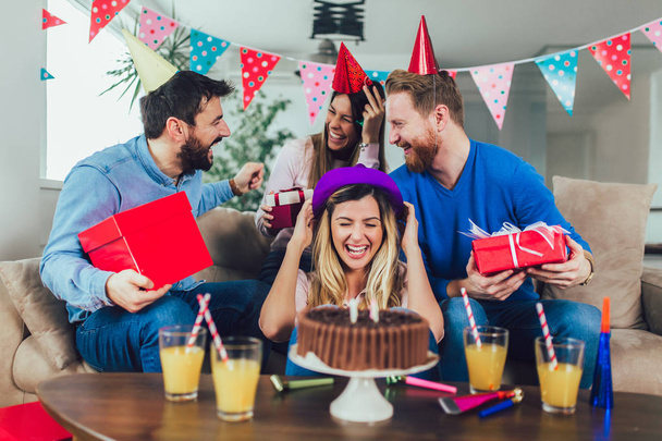 Mladá skupina šťastných přátel oslavujících narozeniny doma a ha - Fotografie, Obrázek