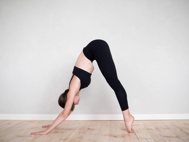 Attractive european girl doing yoga exercise - Foto, Imagen
