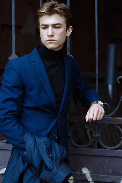 portrait of an attractive young man in a blue suit in the city - Fotografie, Obrázek