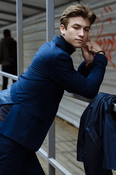 portrait of an attractive young man in a blue suit in the city - Fotoğraf, Görsel