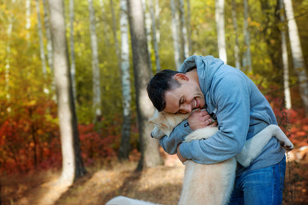 Young man and his dog akita inu - man's best friend - Photo, Image