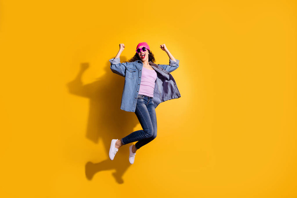 Full body photo of funky lady jumping high overjoyed by discount shopping prices wear casual trendy clothes isolated yellow color background - Valokuva, kuva