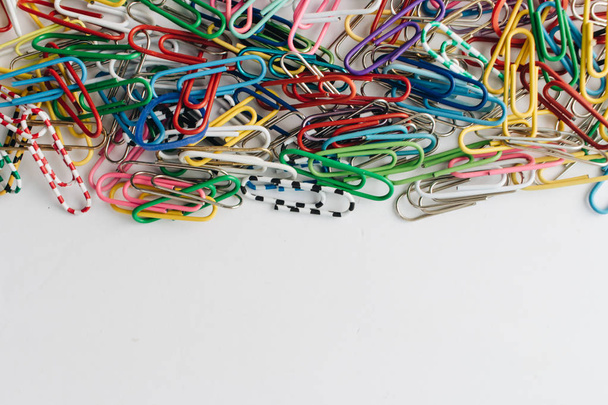 pile of colorful paper clips on white background, flat lay - Photo, image