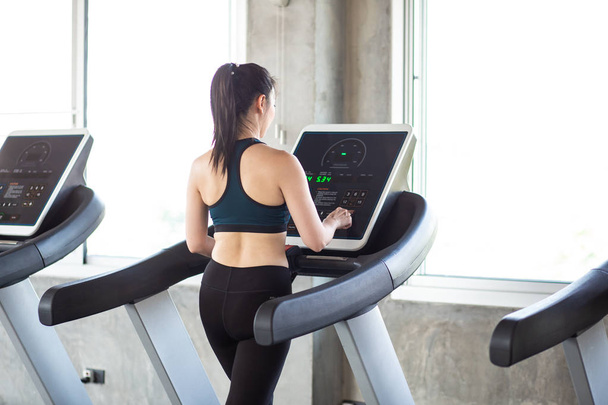 Group of running women on treadmill in fitness gym - 写真・画像