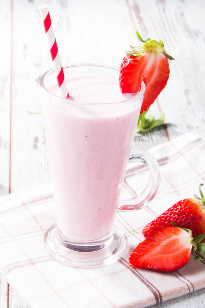 Fresh milk, strawberry on wooden table, assorted protein cocktails with fresh fruits. Natural background. - Фото, зображення