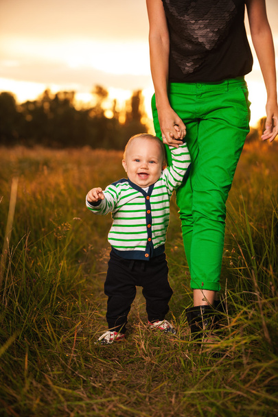 Adorable baby walking around with mother - 写真・画像