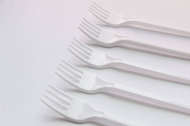 witte plastic vorken platte lay op witte achtergrond - Foto, afbeelding
