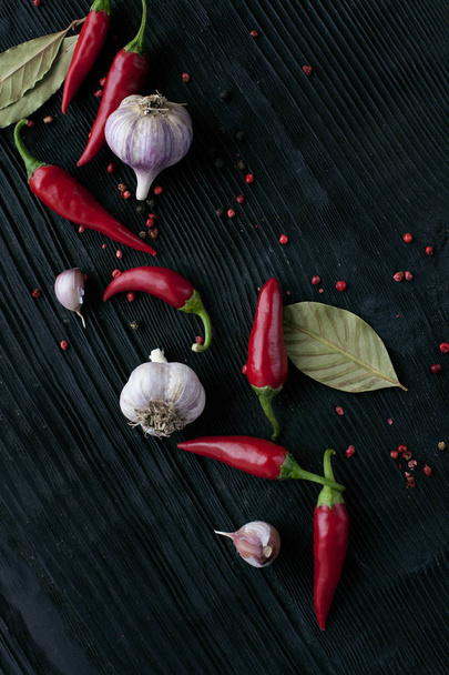  garlic red chili pepper on black wooden dark background - Φωτογραφία, εικόνα
