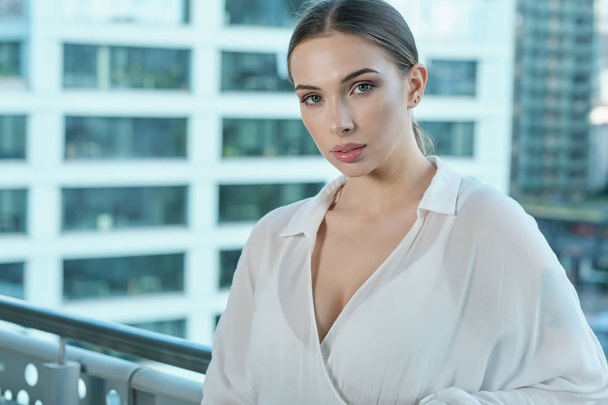 Beautiful business woman on the background of the modern office - Фото, изображение