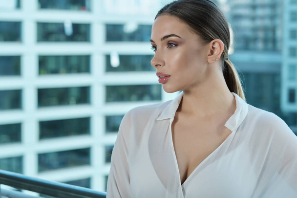 Beautiful business woman on the background of the modern office - Фото, изображение