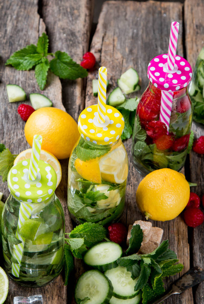 Glasses of lime, lemon soda drinks on wooden background - Фото, зображення