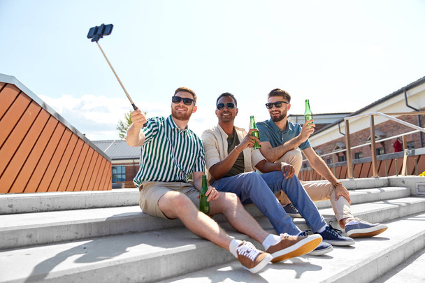men drinking beer and taking selfie by smartphone - 写真・画像