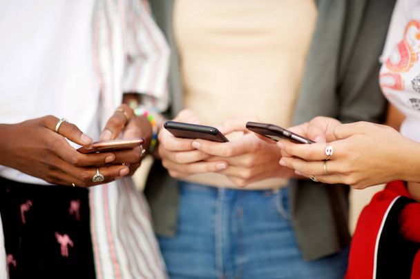 Portrait of group of female hands holding cellphones  - Photo, Image