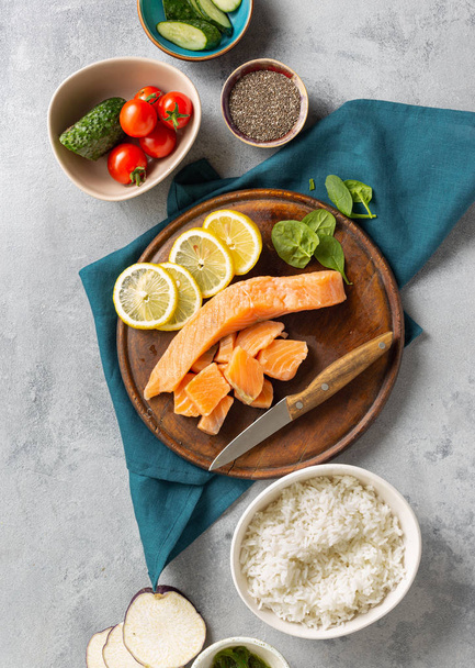 Healthy diet food concept Ingredients for cooking poke bowl with salmon, avocado, vegetables and chia seeds top view - Photo, Image