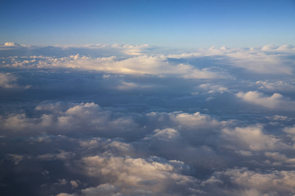Beautiful Clouds in the Sky. Skyscape shot from Airplane - Photo, Image