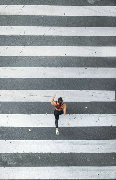 One woman running for zebra crossing - Photo, Image
