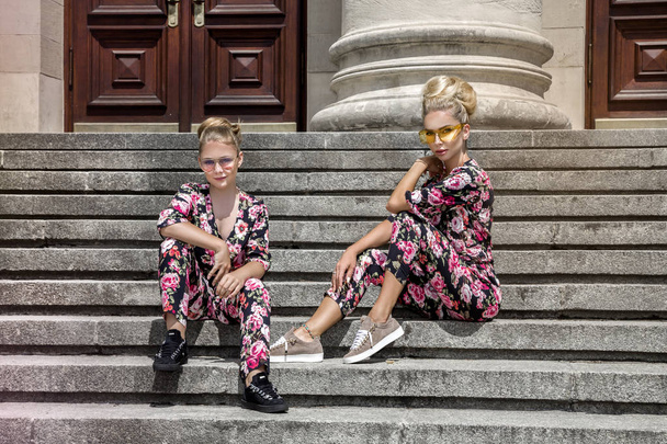 Mother and daughter having fun in same outfits. Fashionable family - Image - Foto, afbeelding