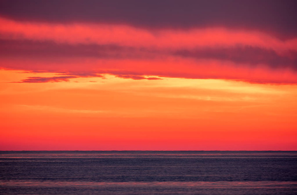 Beautiful red and orange sunset over the sea. - 写真・画像