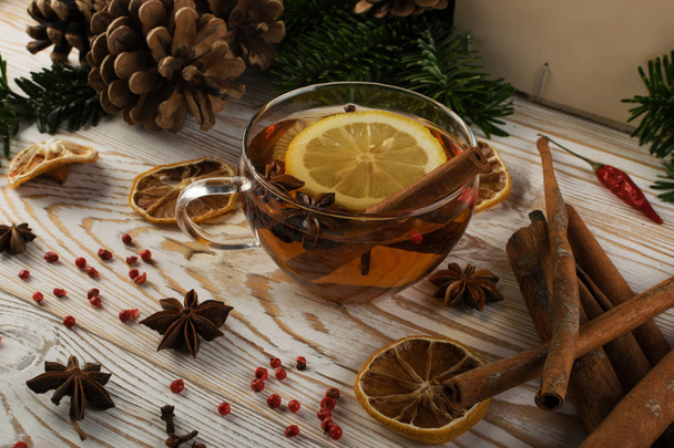 Hot winter drink with spices on festive new year background - Photo, Image