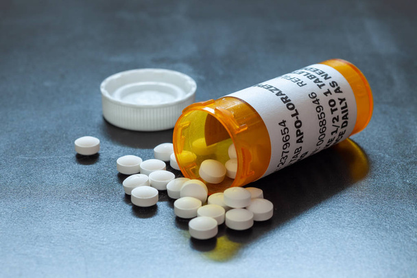 Prescription bottle with backlit Lorezapam tablets. Lorezapam is a generic prescription anti-anxiety medication. - Photo, Image