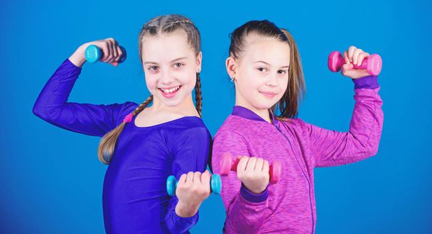 Happy children sportsman with barbell. Sport success. weight lifting for muscules. Childhood activity. Fitness diet for energy health. workout of small girls hold dumbbell. it is my power. power girl - Fotoğraf, Görsel