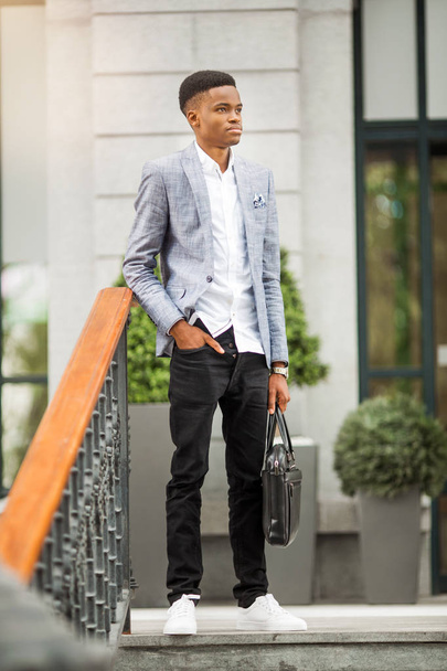 handsome young african man in suit near building - Zdjęcie, obraz