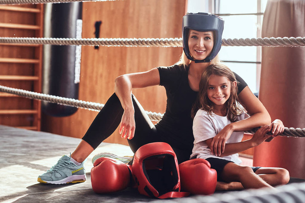 Beautiful boxer trainer and her young ward - Photo, Image