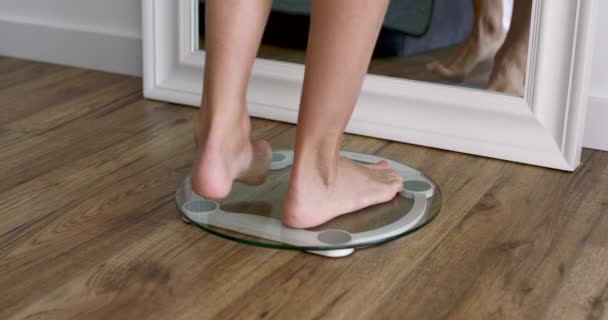 vrouw staat op de weegschaal Barefoot, close-up thuis, maatregelen gewicht - Video