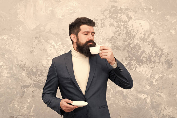 Best coffee served for him. Specialty coffee. Man handsome bearded businessman hold cup of coffee. Coffee break concept. Business people fashion style. Smart casual style clothes for office life - Foto, imagen