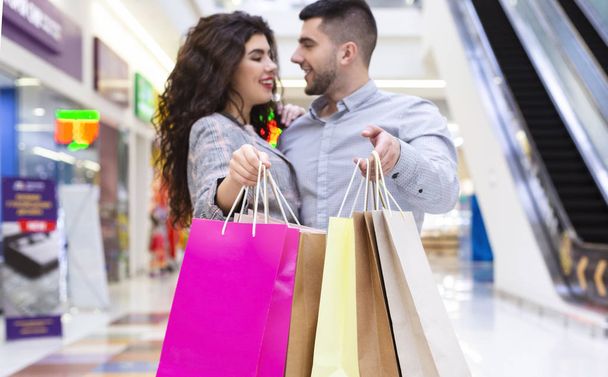 Sales and discounts. Couple with shopping bags - Photo, Image