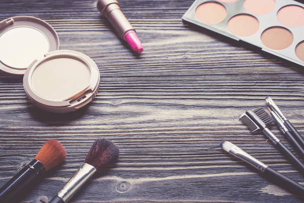 Top view a collection of cosmetic makeup on wooden table backgro - 写真・画像
