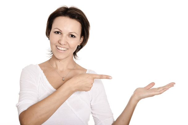Woman pointing on white background - Photo, image