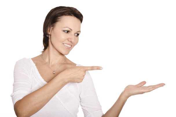 Woman pointing on white background - Foto, immagini