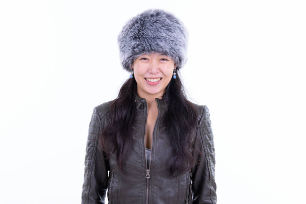 Portrait of happy beautiful Asian woman smiling ready for winter - Foto, Imagem