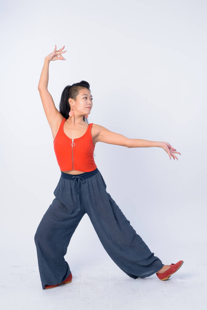 Full body shot of beautiful Asian woman posing ready for yoga sessions - Fotó, kép