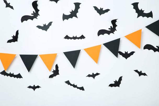 Paper halloween bats and flags on white background - Foto, Imagen